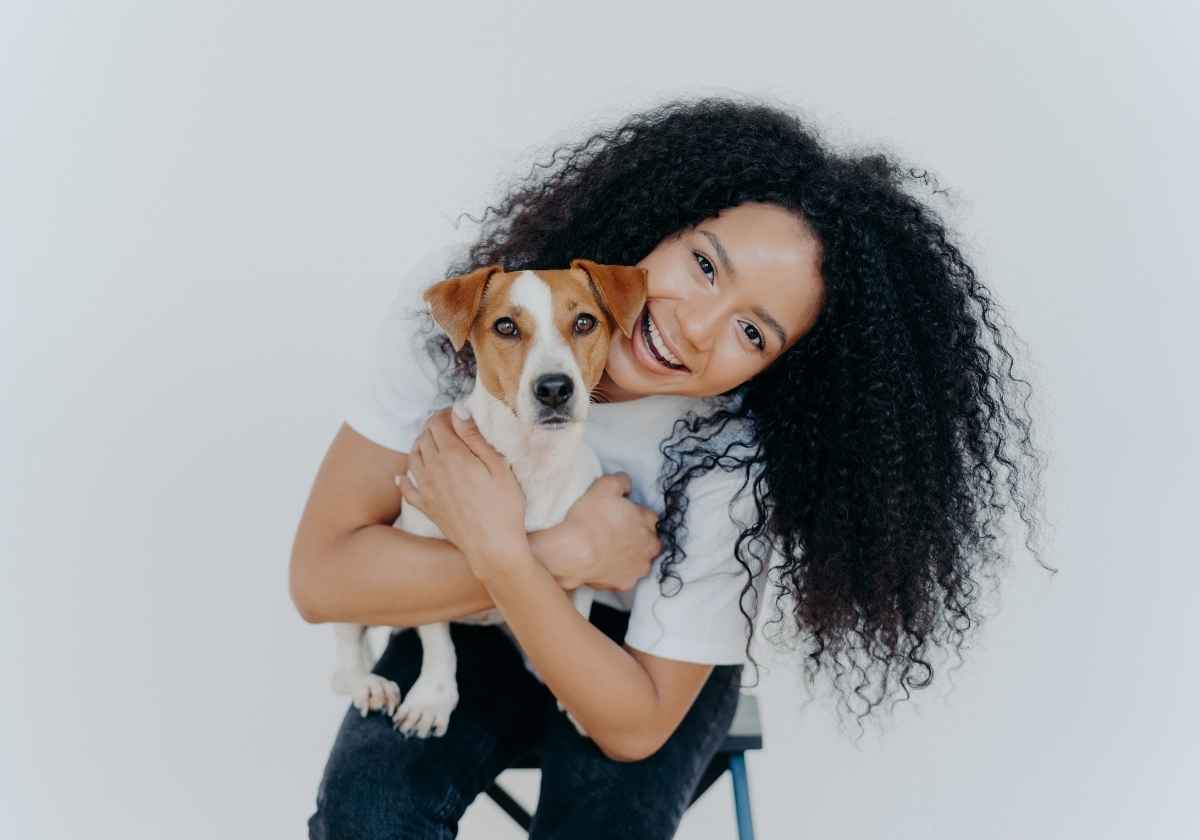 Smiling woman holding dog
