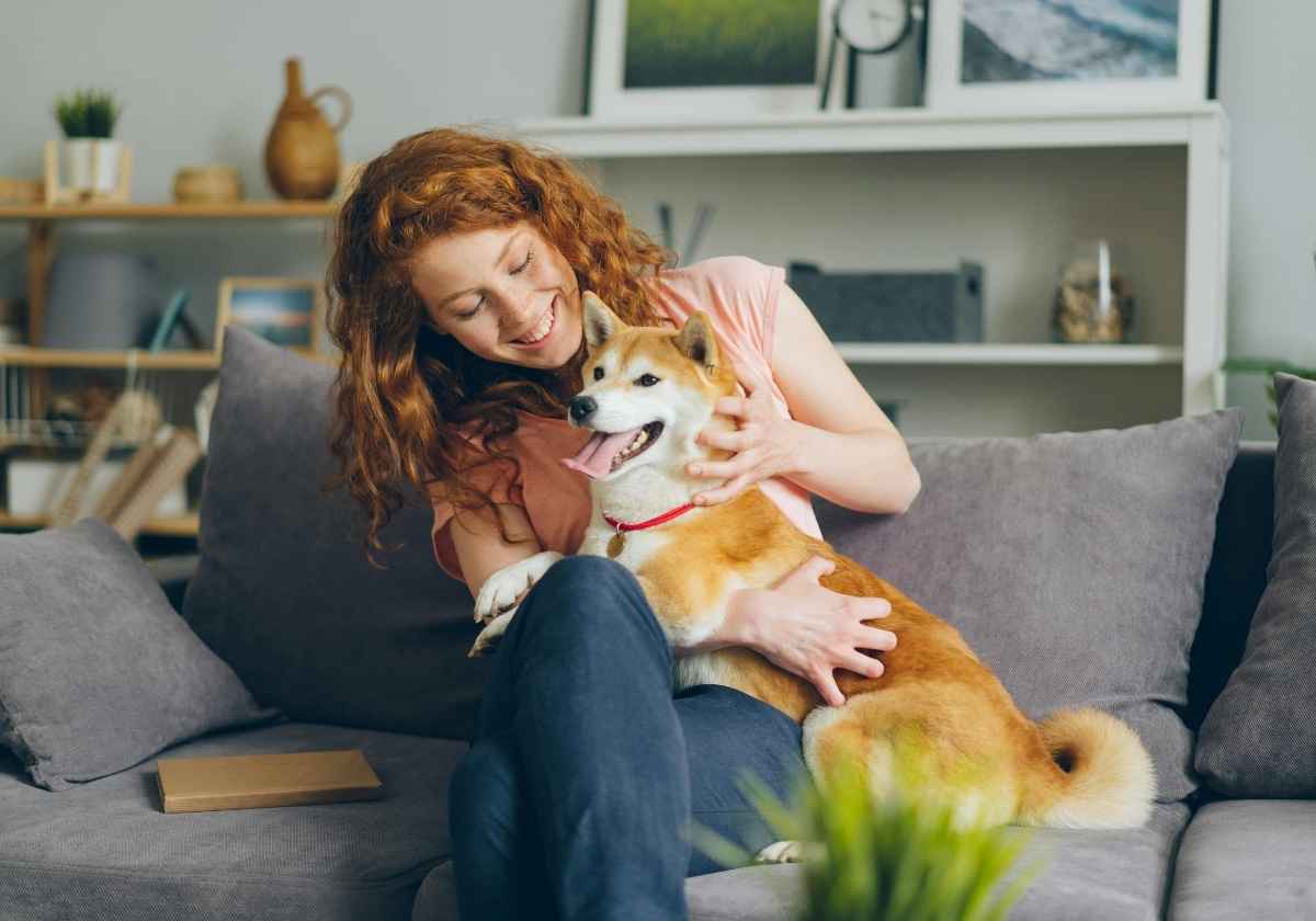 Woman petting happy dog.